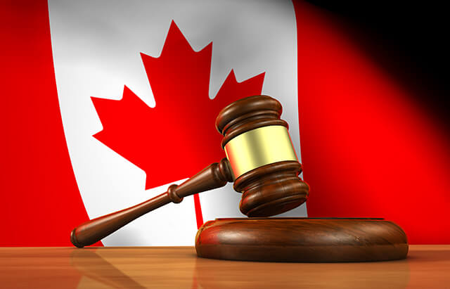 image of a gavel in front of a Canadian Flag